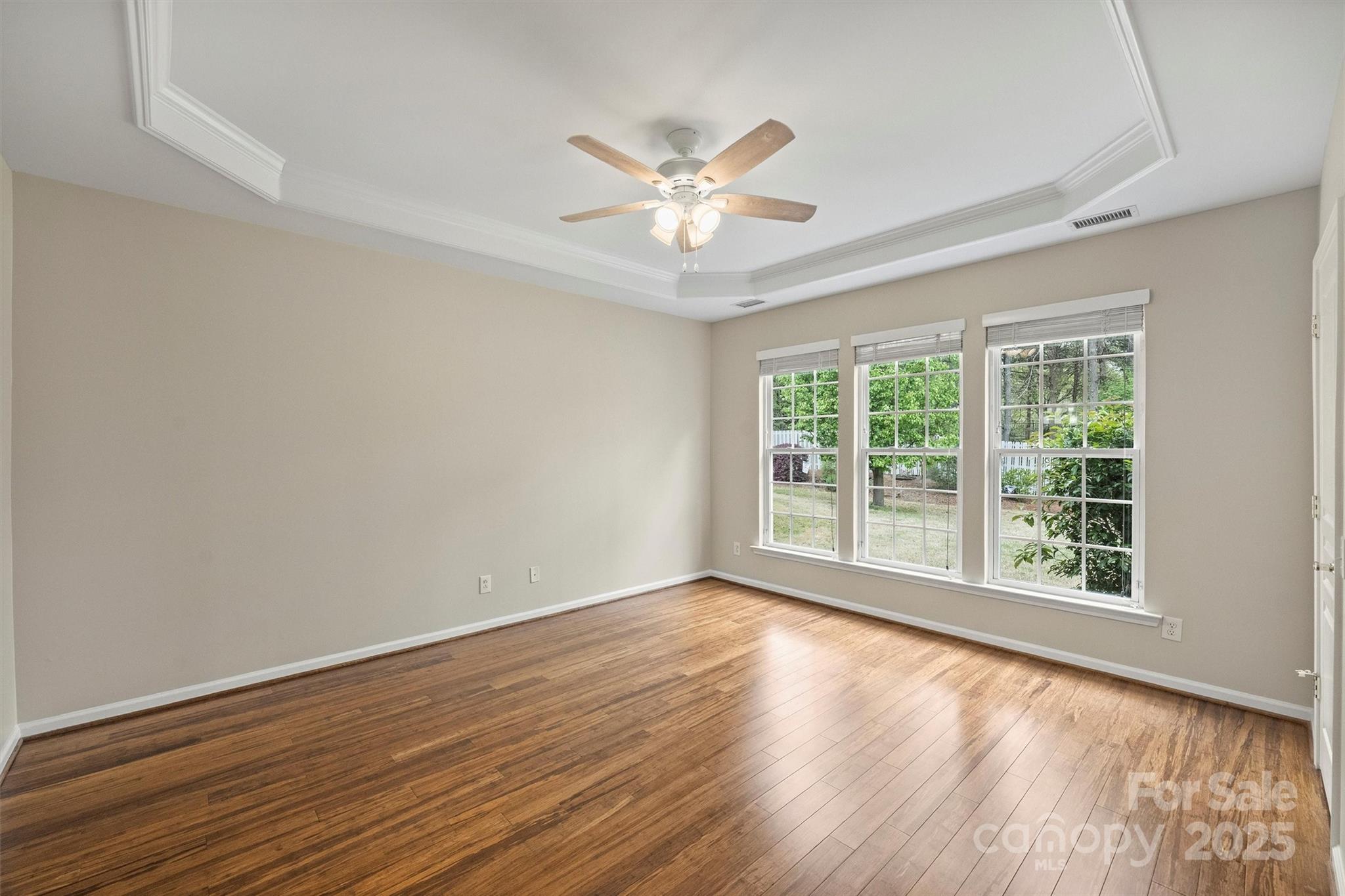11422 Nevermore Way Charlotte, NC 28277 - Photo 18 of 34 a view of an empty room with wooden floor and a window