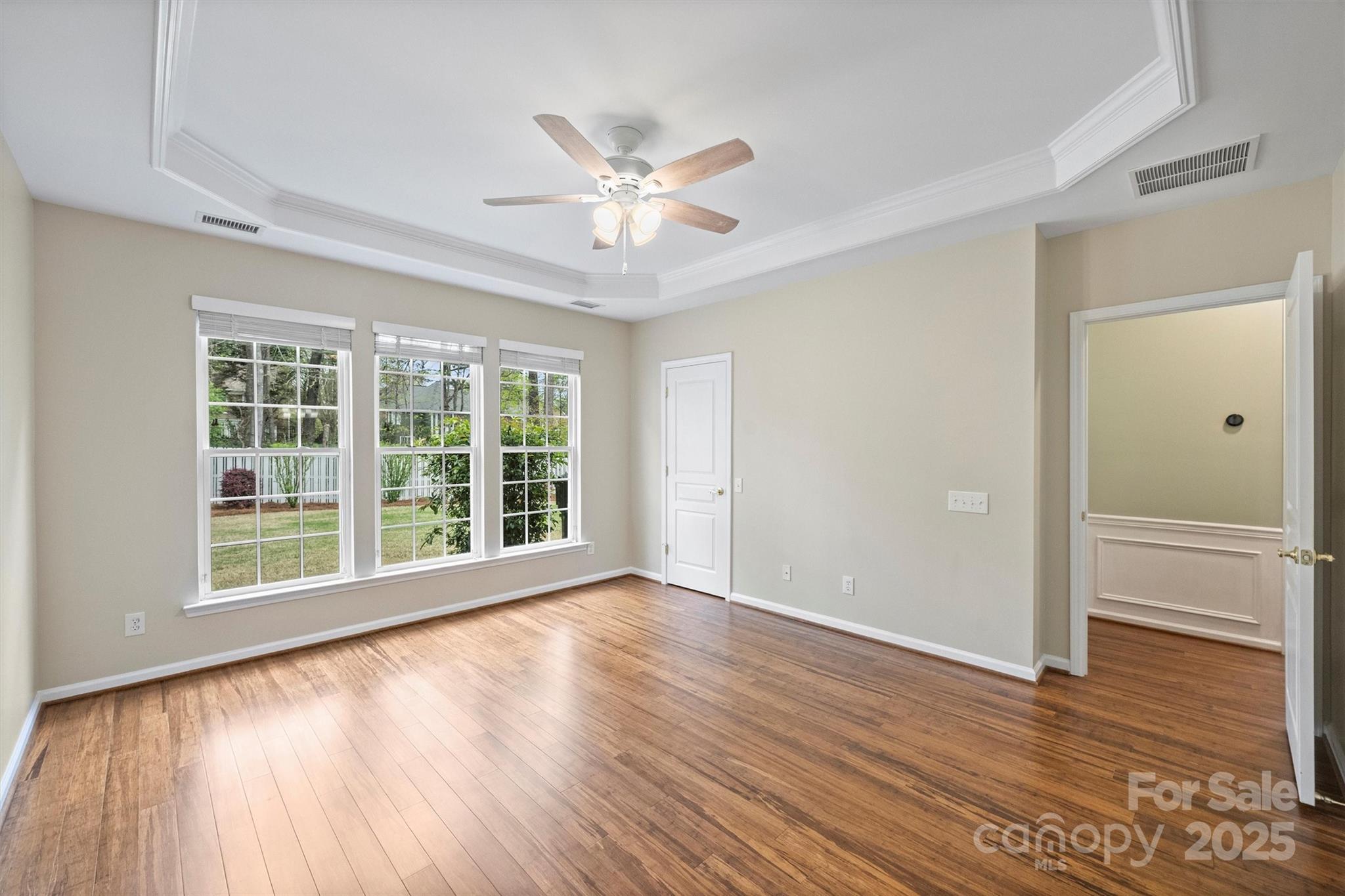 11422 Nevermore Way Charlotte, NC 28277 - Photo 19 of 34 a view of an empty room with wooden floor and a window