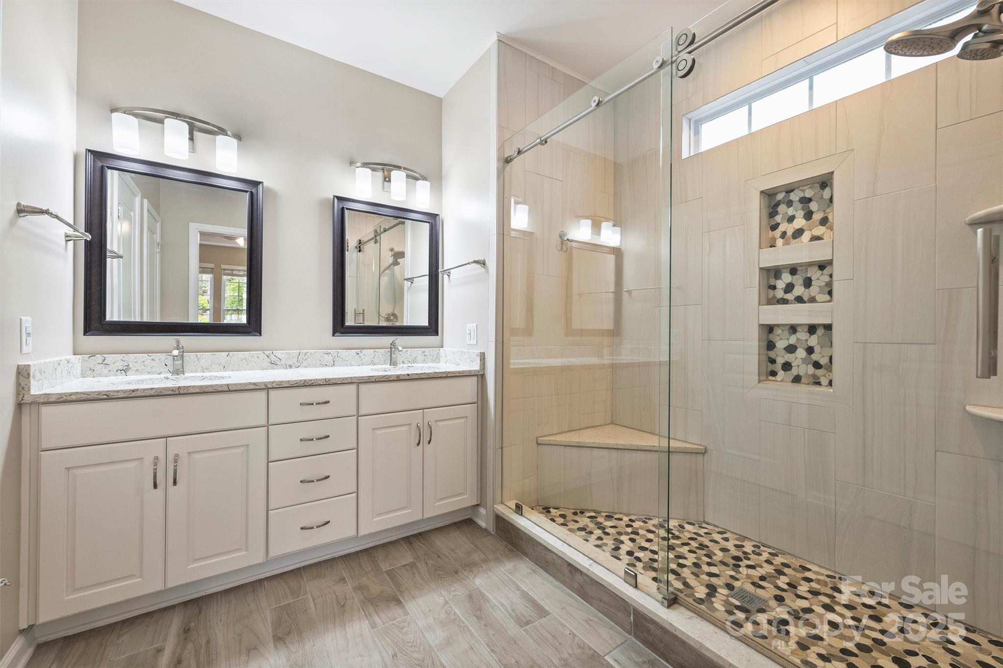 11422 Nevermore Way Charlotte, NC 28277 - Photo 20 of 34 a bathroom with a double vanity sink a mirror and a shower