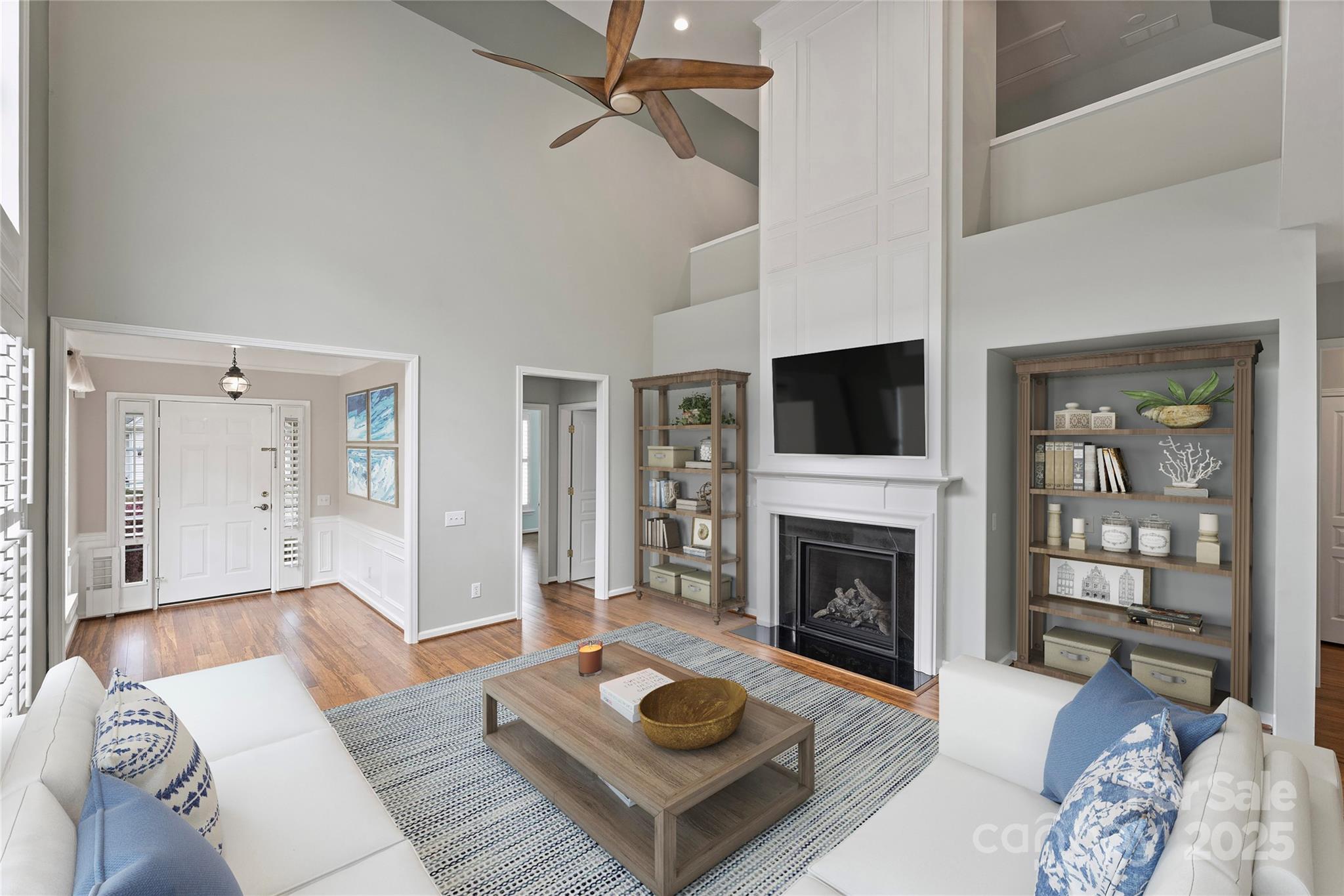 11422 Nevermore Way Charlotte, NC 28277 - Photo 2 of 34 a living room with furniture a fireplace and a flat screen tv