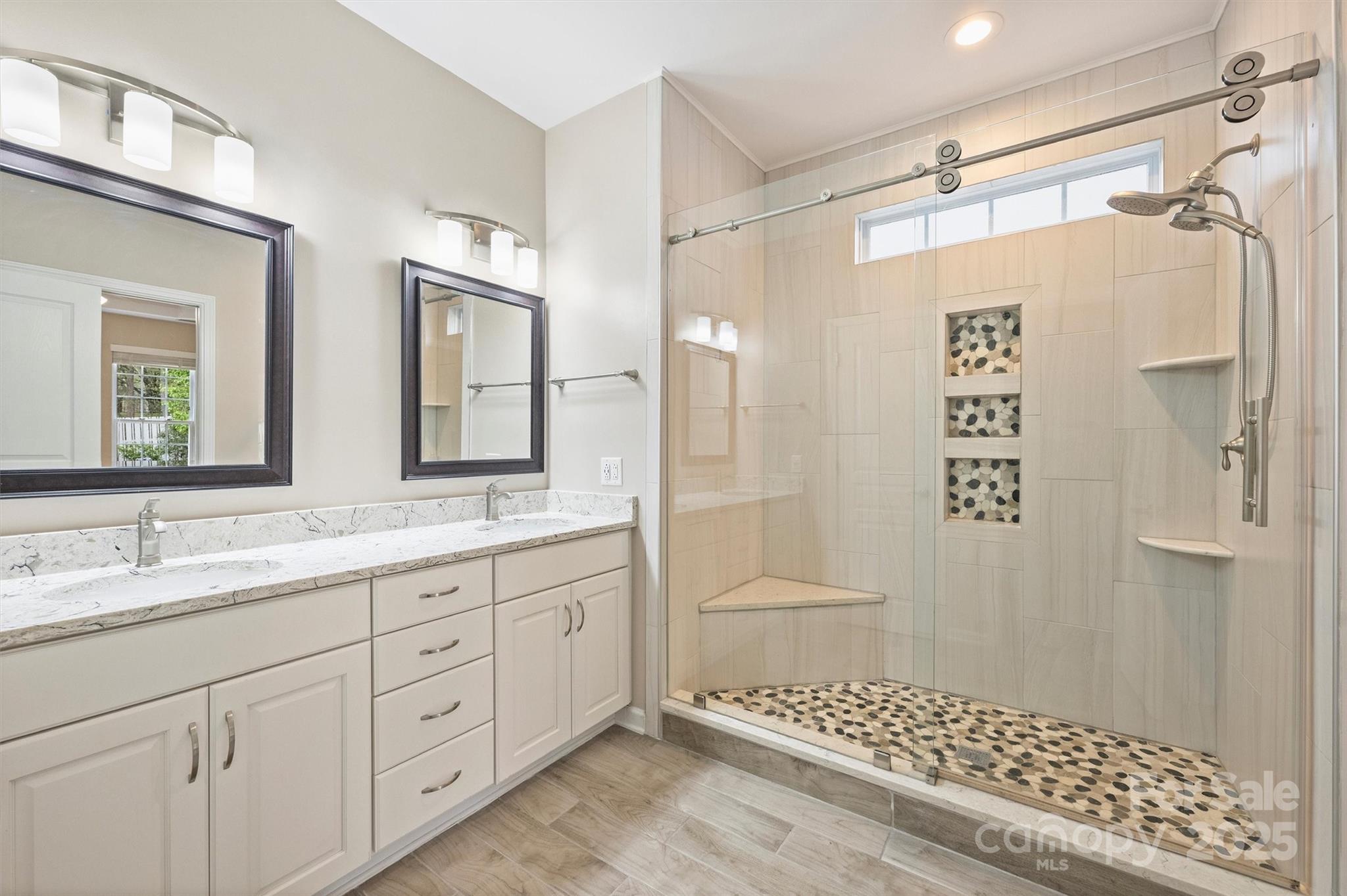 11422 Nevermore Way Charlotte, NC 28277 - Photo 21 of 34 a bathroom with a double vanity sink toilet and shower
