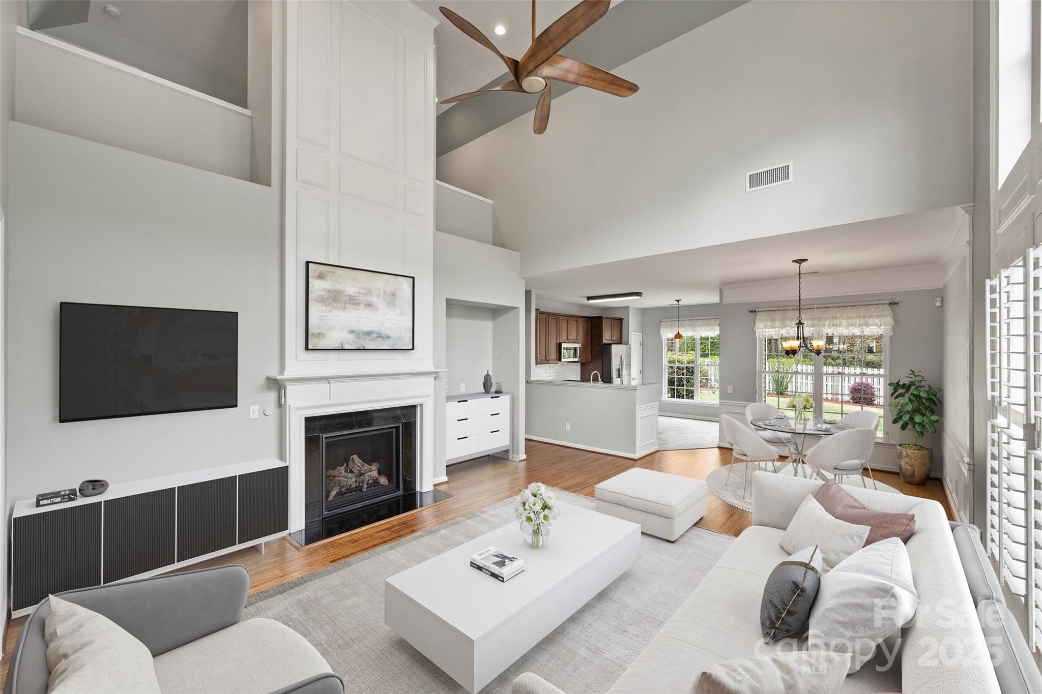 11422 Nevermore Way Charlotte, NC 28277 - Photo 4 of 34 a living room with furniture a fireplace and a flat screen tv