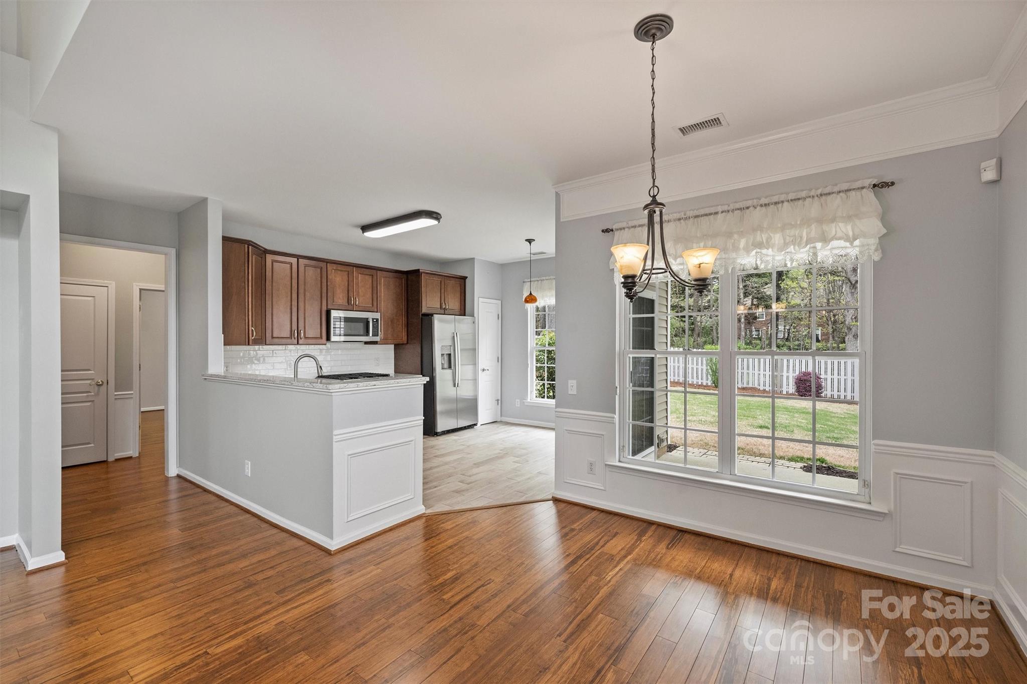 11422 Nevermore Way Charlotte, NC 28277 - Photo 9 of 34 a view of a kitchen with wooden floor and a window