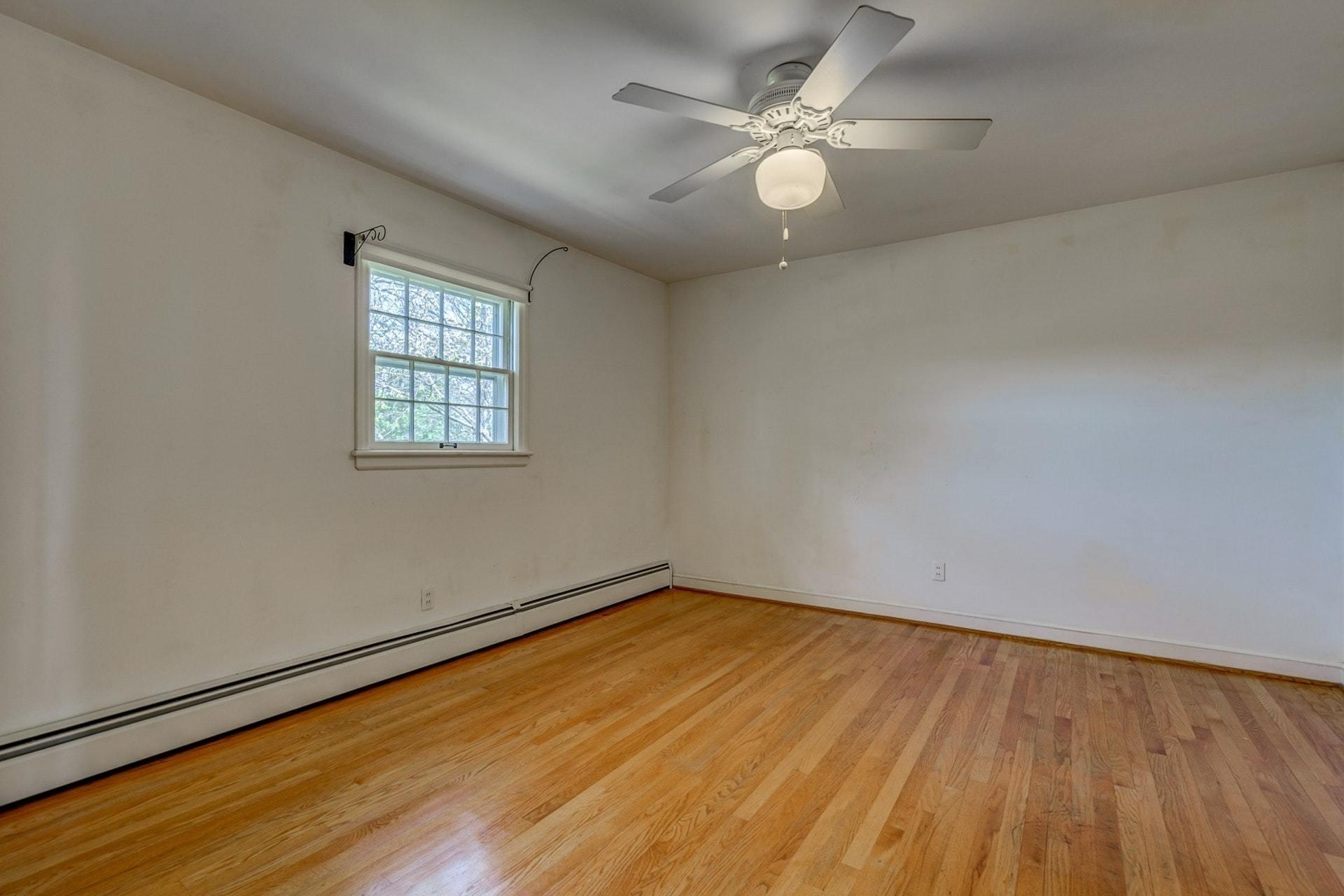 5571 Highfields Road Roanoke, VA 24018 - Photo 23 of 45 an empty room with wooden floor and windows