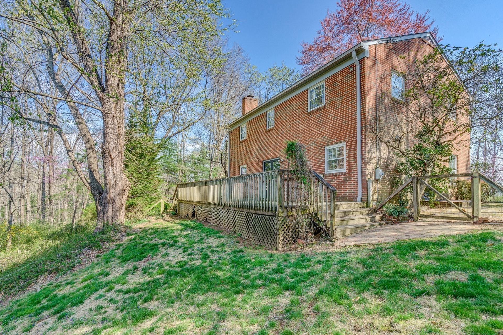 5571 Highfields Road Roanoke, VA 24018 - Photo 31 of 45 a view of a small house with a big yard and large trees