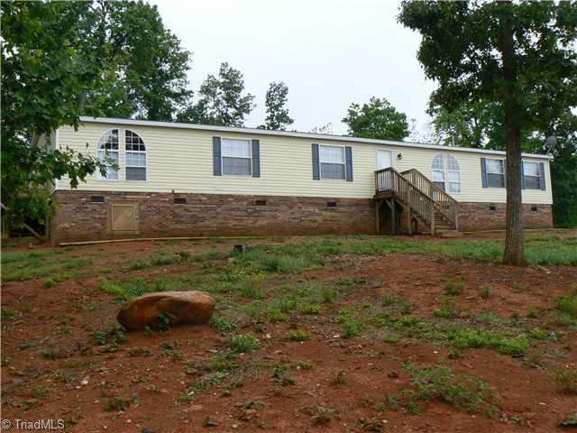 216 Nance Road Denton, NC 27239 - Photo 1 of 16 Exterior Front. This 2005 Model Home with permanent foundation is located on 4.2 acres in a sparsely populated rural community. Over 2350 square feet offerings spacious rooms including LR, DR and Den with fireplace and wet bar. Private and peaceful.