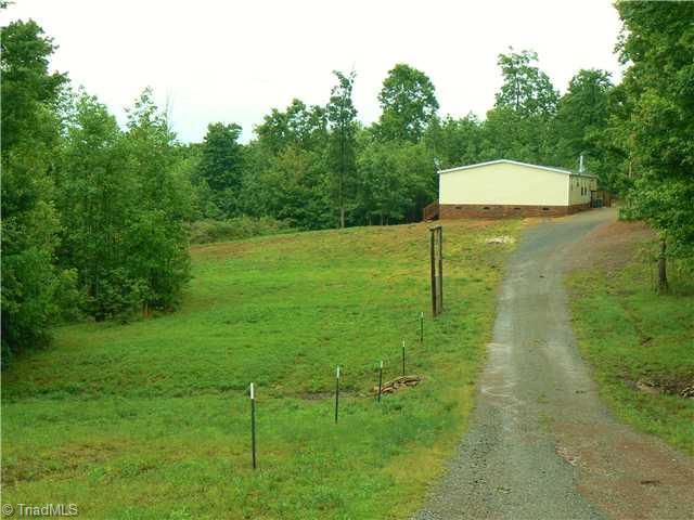 216 Nance Road Denton, NC 27239 - Photo 2 of 16 Land/Lot. Approach from Nance Road. Approx. 2 acres are cleared, remainder in woods. Metal fence posts are in place around perimeter of property excluding drive and home site.