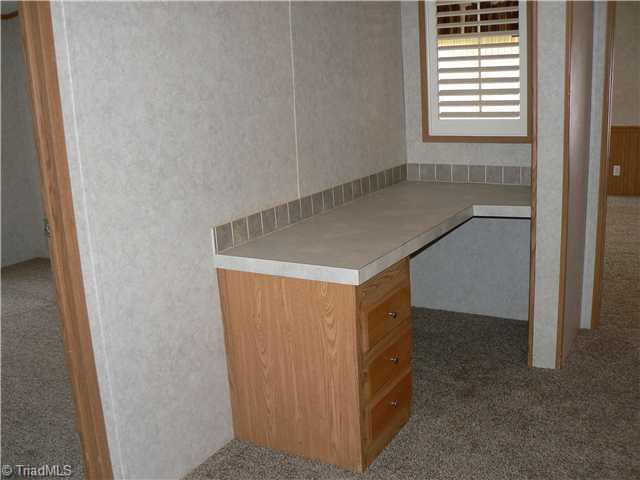 216 Nance Road Denton, NC 27239 - Photo 12 of 16 Computer Room. This wide space in the hall has a built-in desk convenient to the entire house. The "window" at end of desk looks into the Den/Family Room.