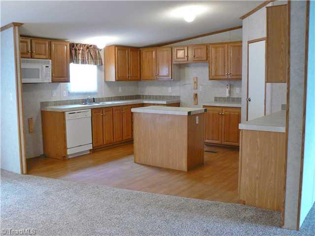 216 Nance Road Denton, NC 27239 - Photo 4 of 16 Kitchen. Kitchen is 12 x 14 10" and has a pantry in corner behind the white door. Double stainless steel sinks, Microwave and dishwasher.