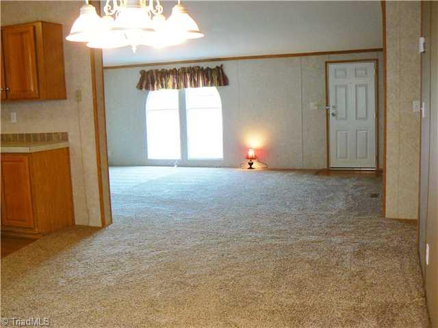216 Nance Road Denton, NC 27239 - Photo 5 of 16 Dining Room. Taken from Dining Room looking into Living Room. DR is 10 x 15 . LR is 14 10" x 19 3". Lots of room for the family in this home. All new carpet, lighting and more. Home in good condition.