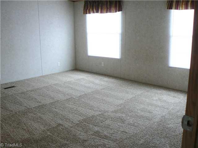 216 Nance Road Denton, NC 27239 - Photo 6 of 16 Master Bedroom. This Master Bedroom is 14 10" x 15 11". The Master Suite is very spacious with huge bath and walk-in closet. This is a split bedroom plan with other bedrooms on hall beyond living room.