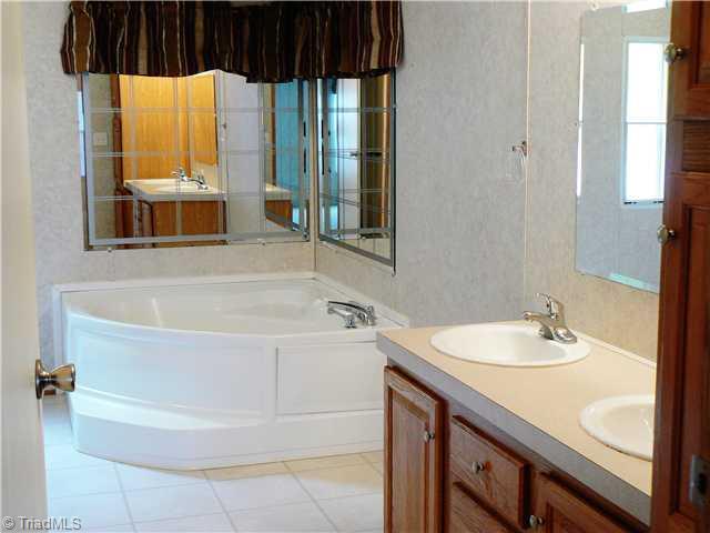 216 Nance Road Denton, NC 27239 - Photo 7 of 16 Master Bath/Spa. The Master Bath is 8 9" x 14 10". It has double sinks, garden tub, separate shower and walk in closet. Note the tall linen cabinet on right side of picture.