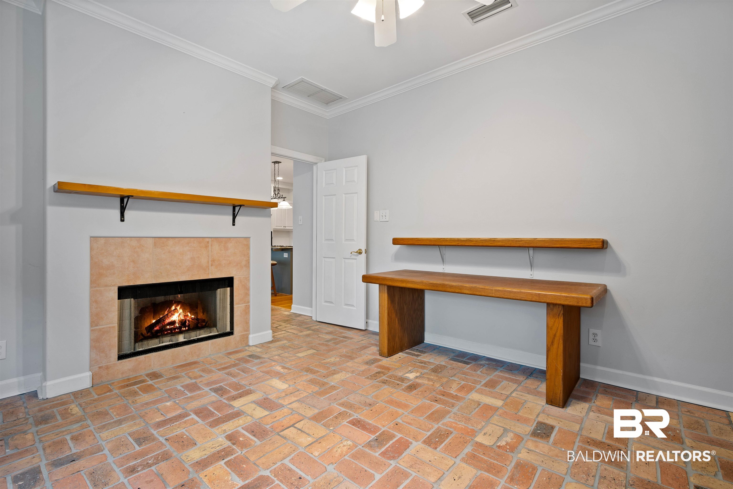 204 General Canby Loop Daphne, AL 36527 - Photo 13 of 36 Interior space featuring ceiling fan, crown molding, and a tiled fireplace