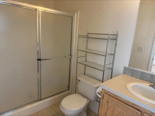 a bathroom with a toilet a sink and shower