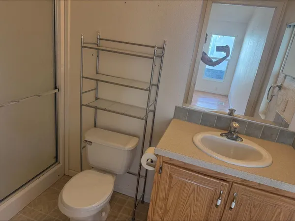 a white toilet sitting next to a bathroom sink
