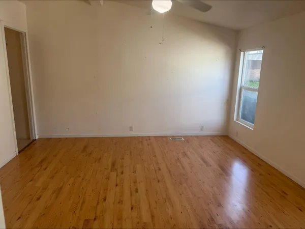 a view of an empty room and wooden floor