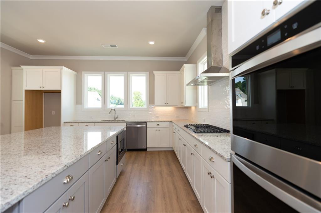 5590 Broad River View Peachtree Corners, GA 30092 - Photo 13 of 37 a large kitchen with a stove sink and cabinets