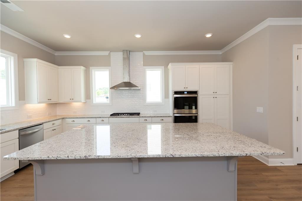 5590 Broad River View Peachtree Corners, GA 30092 - Photo 15 of 37 a kitchen with granite countertop white cabinets and stainless steel appliances