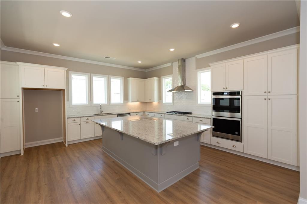 5590 Broad River View Peachtree Corners, GA 30092 - Photo 16 of 37 a large kitchen with granite countertop a large counter top and stainless steel appliances