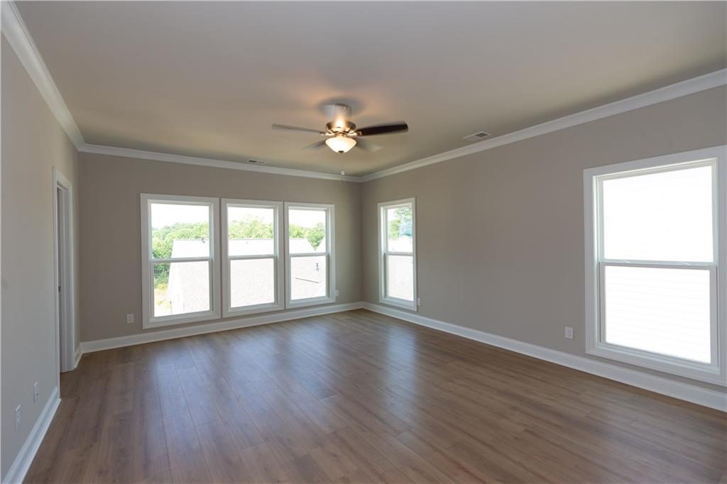 5590 Broad River View Peachtree Corners, GA 30092 - Photo 9 of 37 a view of an empty room with wooden floor and a window