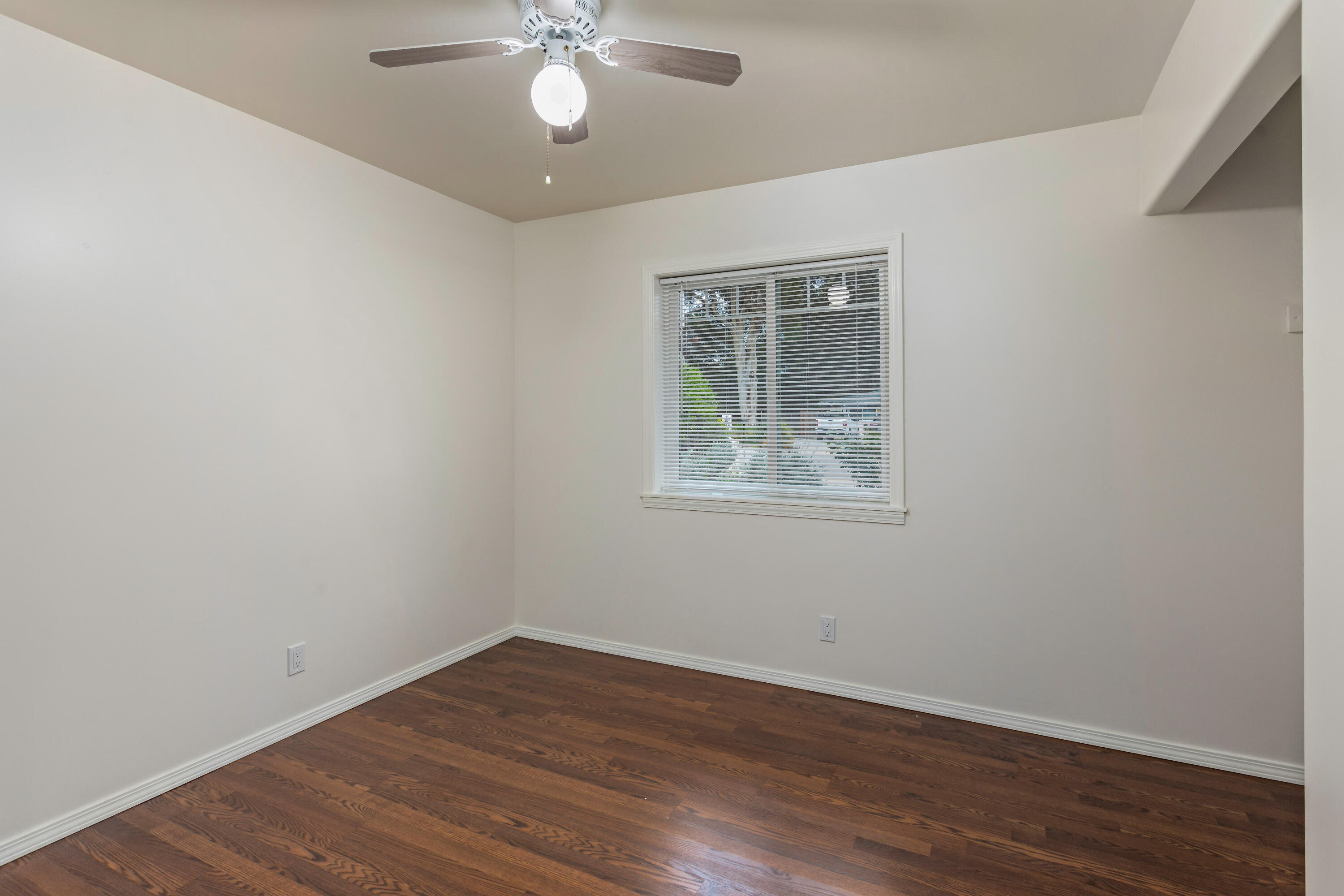 253 Pebble Beach Drive Goleta, CA 93117 - Photo 19 of 27 a view of an empty room with wooden floor and a window