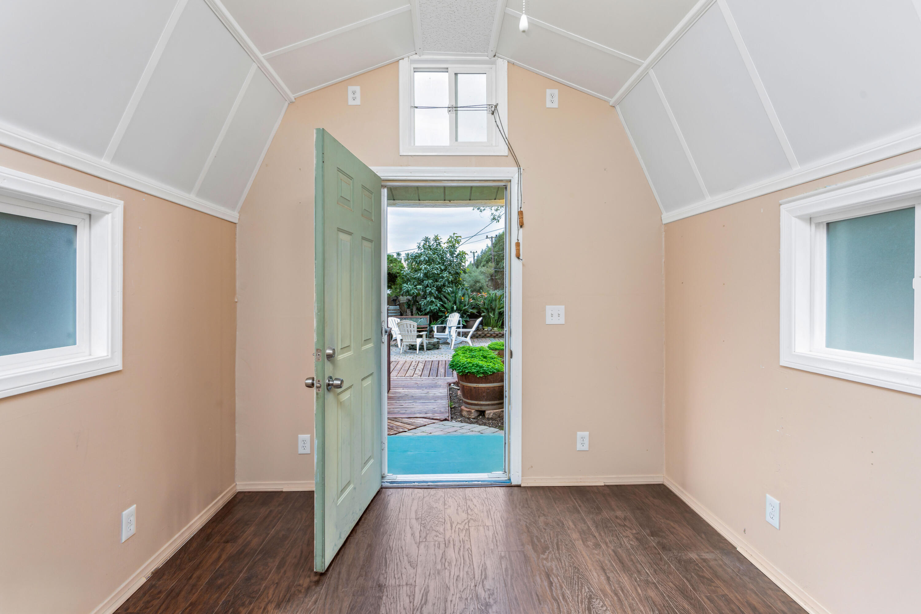 253 Pebble Beach Drive Goleta, CA 93117 - Photo 23 of 27 an empty room with wooden floor a ceiling fan and windows