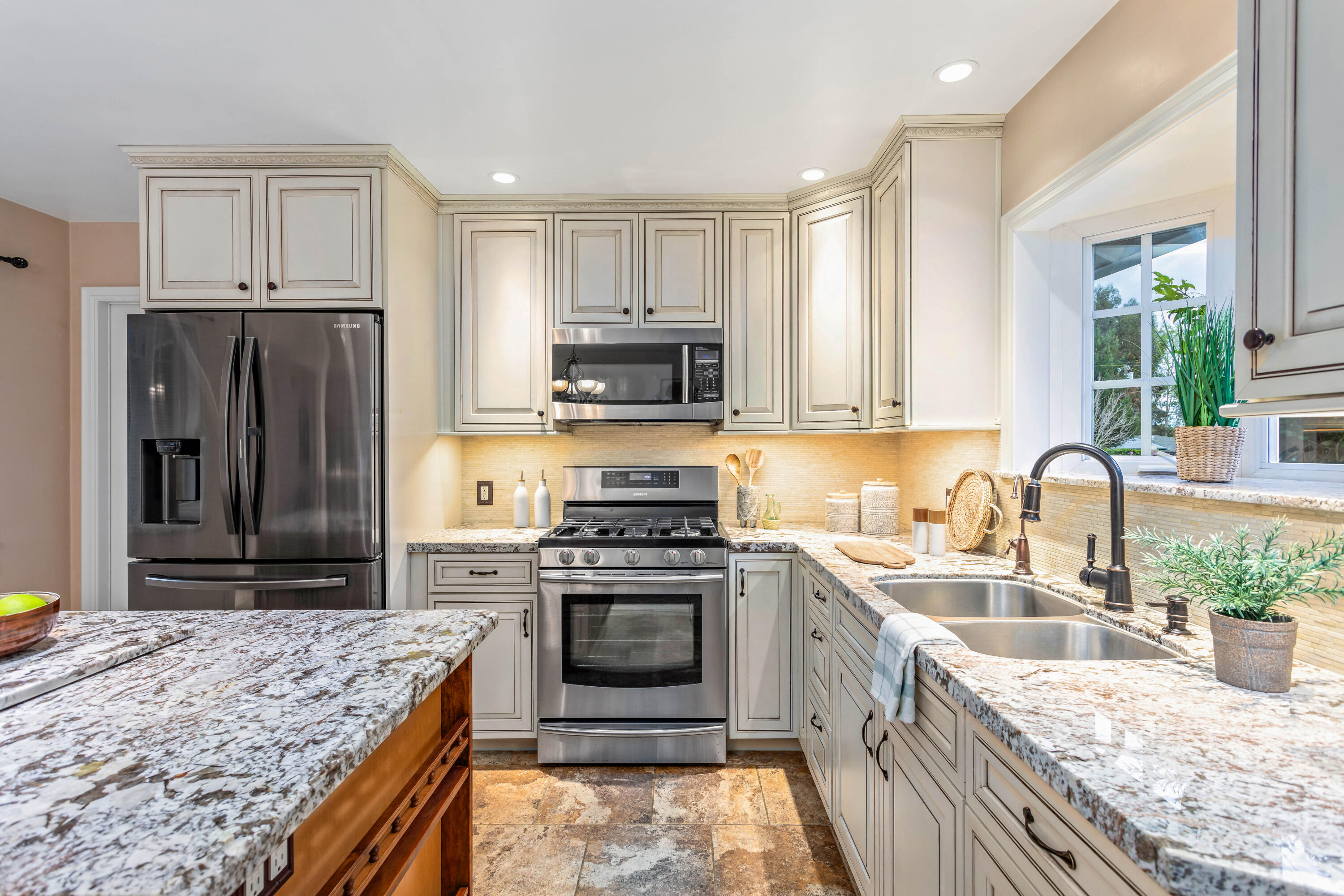253 Pebble Beach Drive Goleta, CA 93117 - Photo 6 of 27 a kitchen with kitchen island granite countertop a stove sink and refrigerator