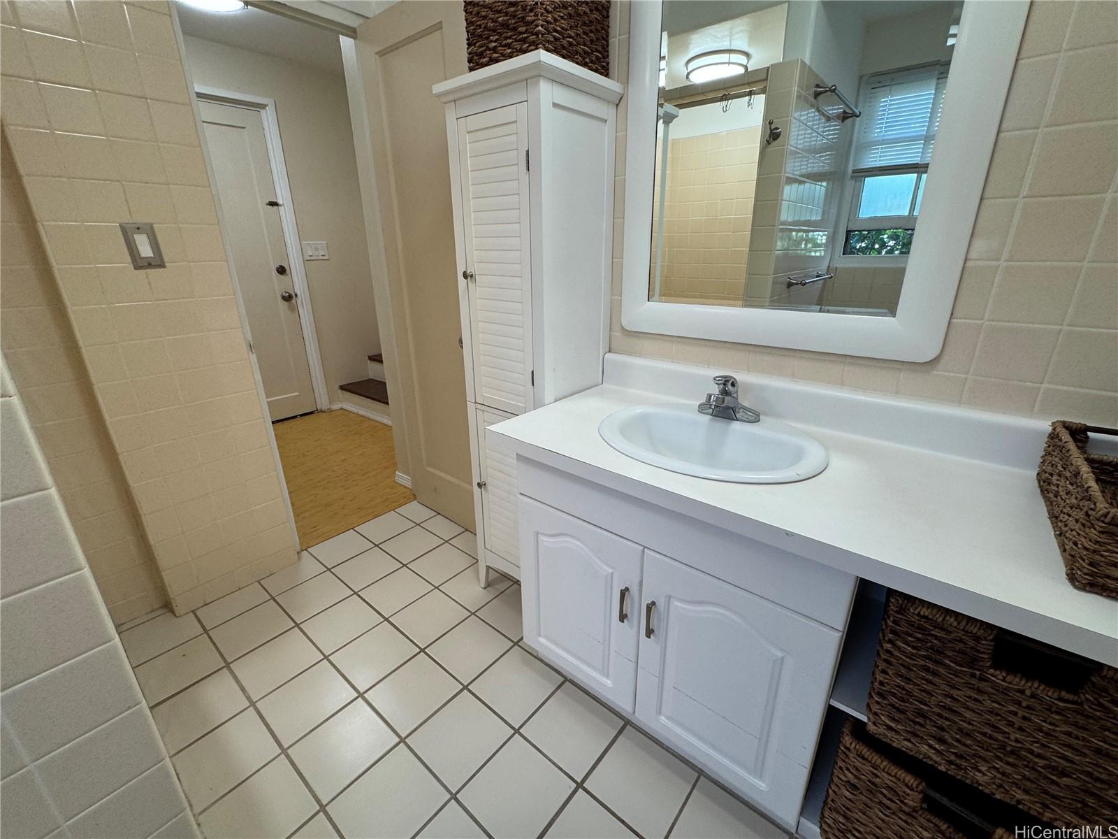 320 Hao Street Honolulu, HI 96821 - Photo 8 of 15 a bathroom with a sink and a mirror