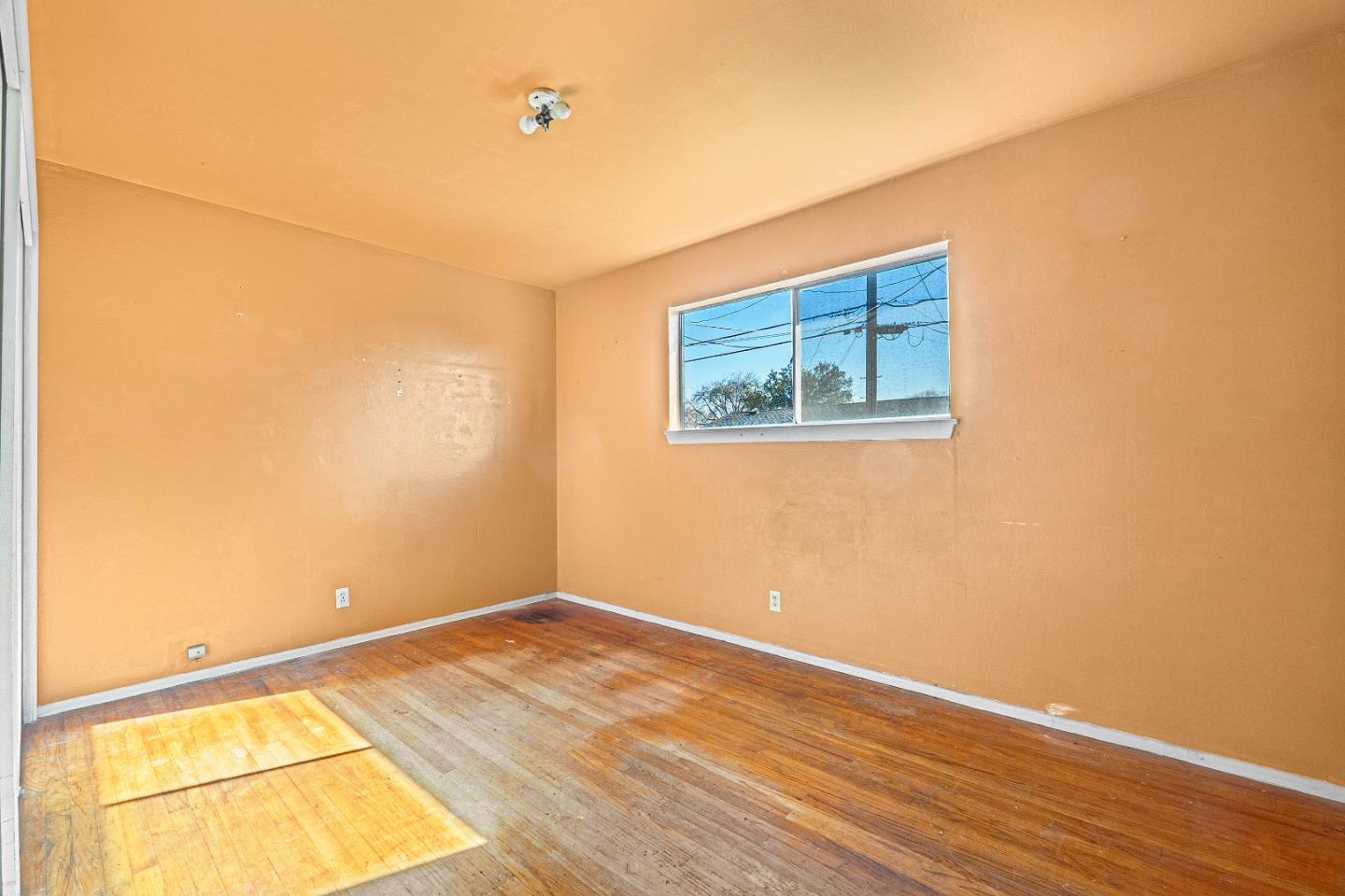 172 Manferd Street Milpitas, CA 95035 - Photo 22 of 45 an empty room with wooden floor and windows