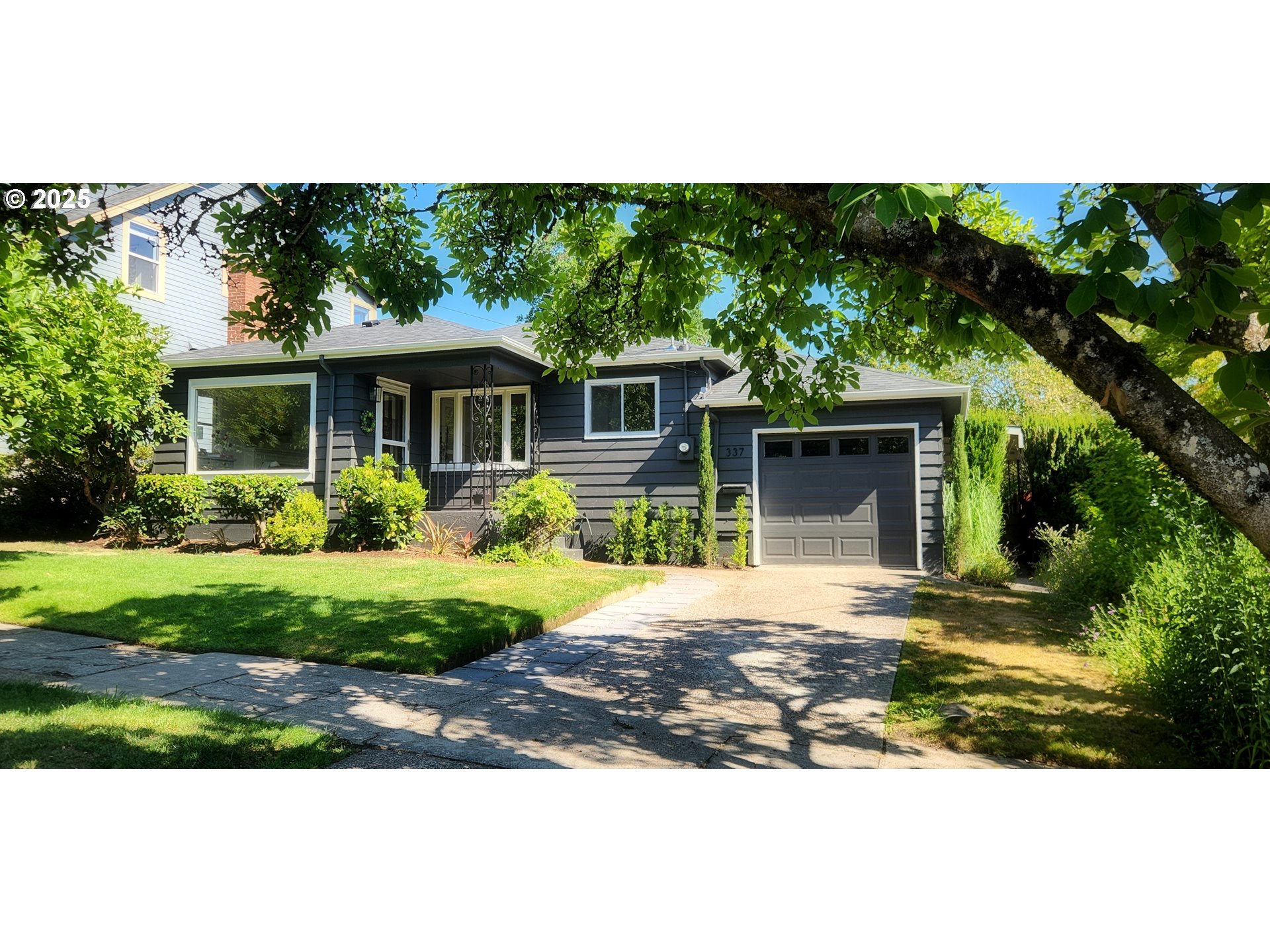 a front view of a house with a garden and patio
