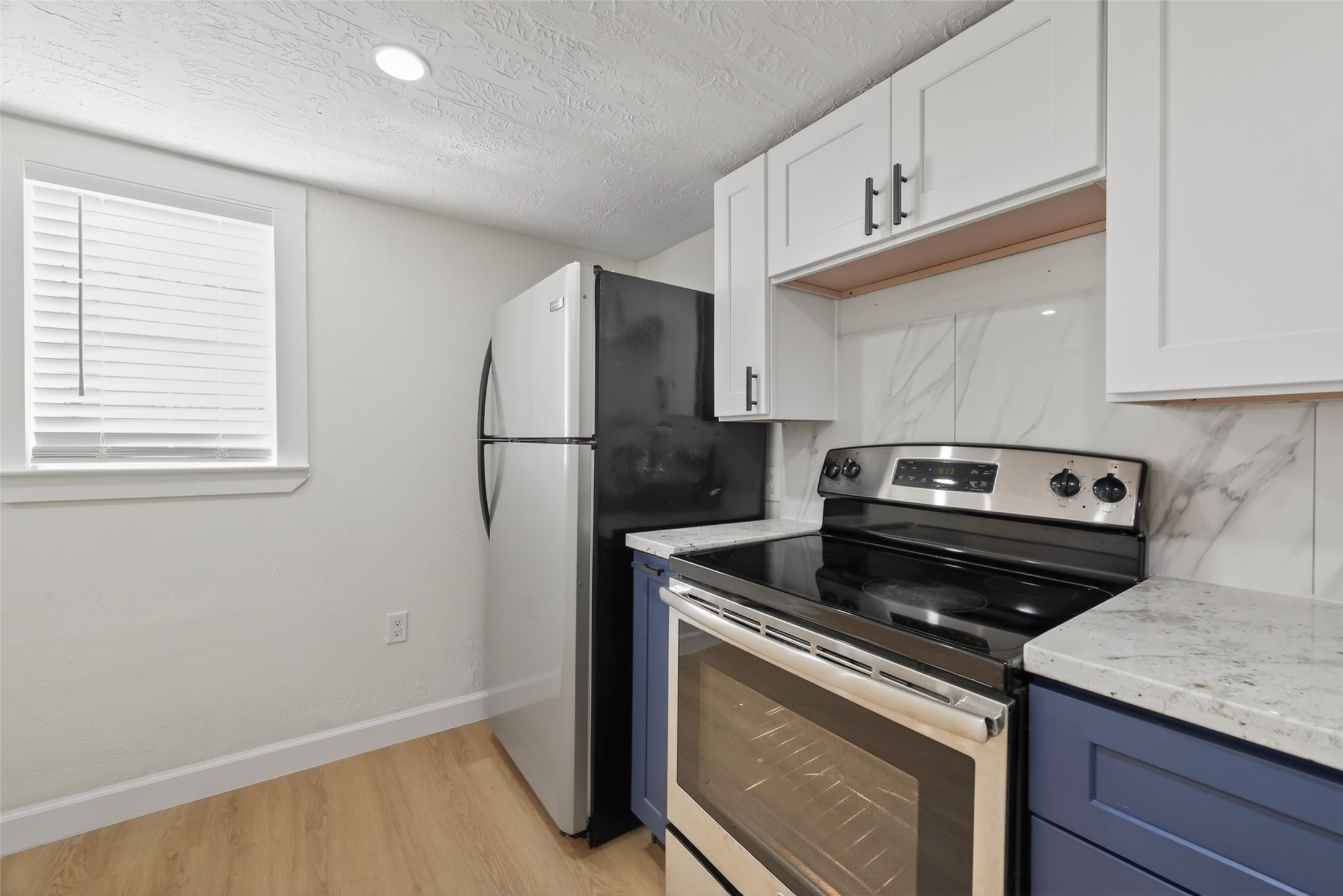 2118 Webster Street, Unit 3 Houston, TX 77003 - Photo 13 of 29 a kitchen with a stove microwave and refrigerator