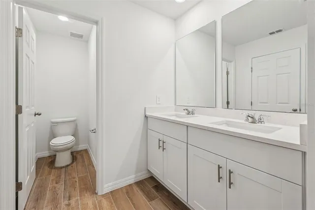 a bathroom with a sink a toilet and a mirror