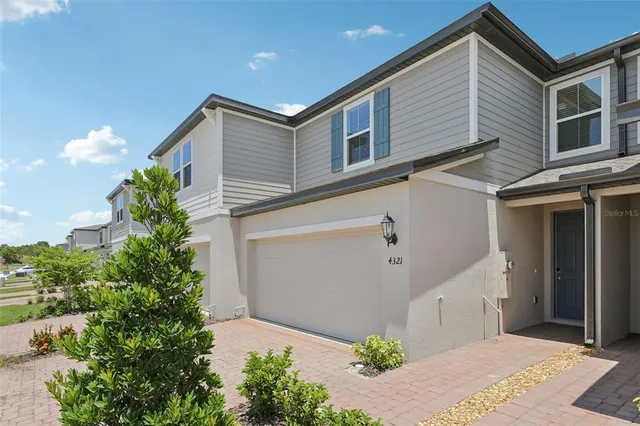 a front view of a house with plants