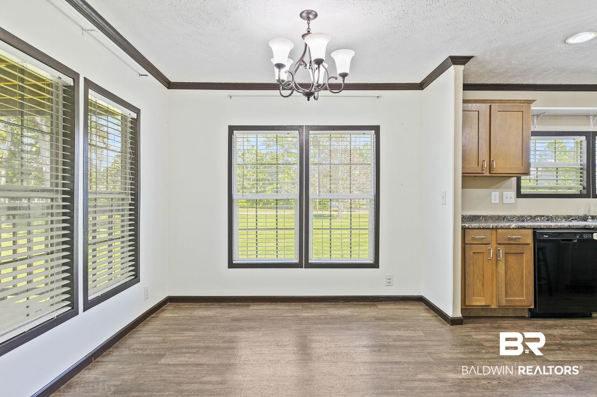 35641 County Road 39 Stapleton, AL 36578 - Photo 18 of 46 Interior space with dishwasher, pendant lighting, dark hardwood / wood-style flooring, ornamental molding, and a notable chandelier