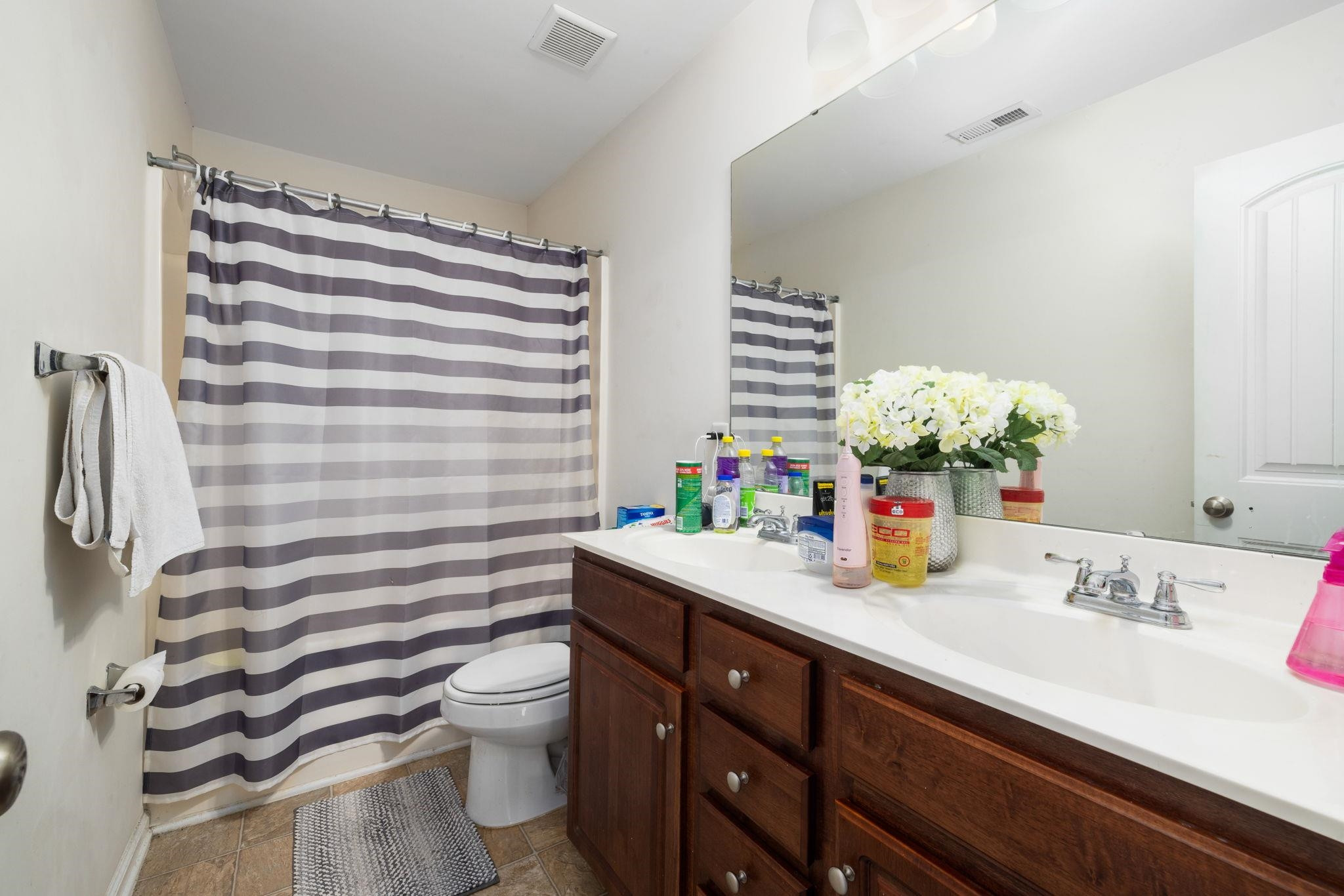 3853 Volkswalk Place Raleigh, NC 27610 - Photo 12 of 19 a bathroom with a sink a toilet and shower curtain