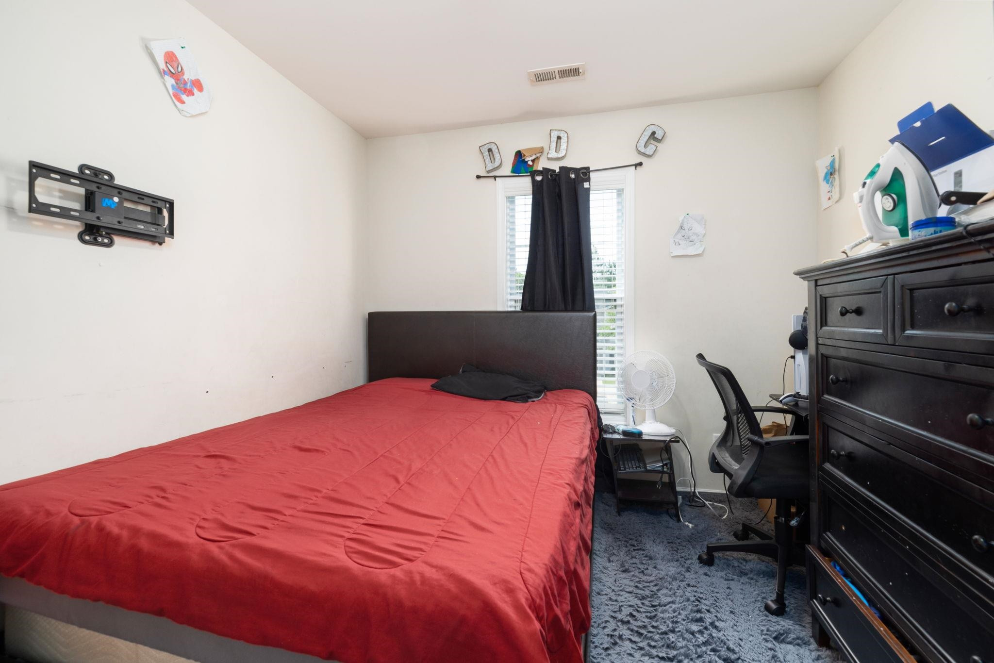 3853 Volkswalk Place Raleigh, NC 27610 - Photo 13 of 19 a bedroom with a bed and a dresser in it