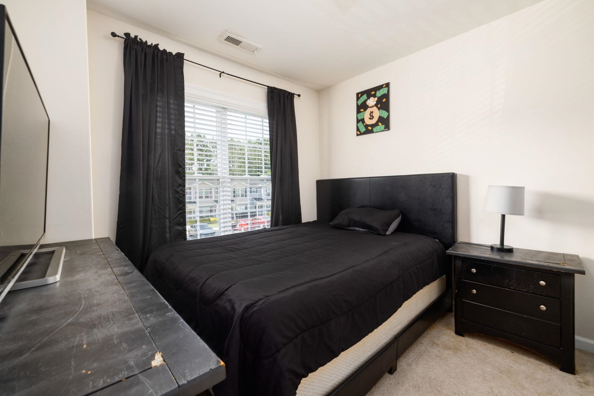 3853 Volkswalk Place Raleigh, NC 27610 - Photo 15 of 19 a bedroom with a bed and a window