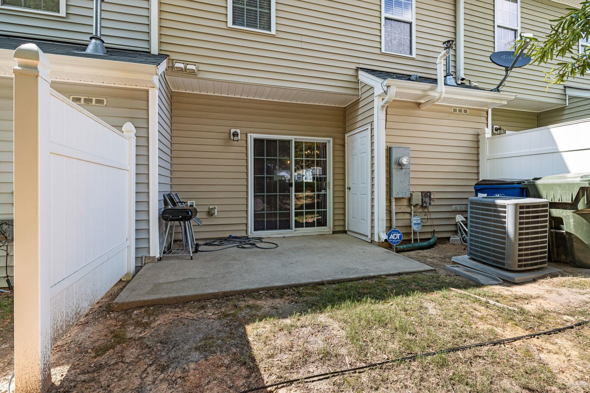 3853 Volkswalk Place Raleigh, NC 27610 - Photo 19 of 19 a view of a house with a patio and wooden fence