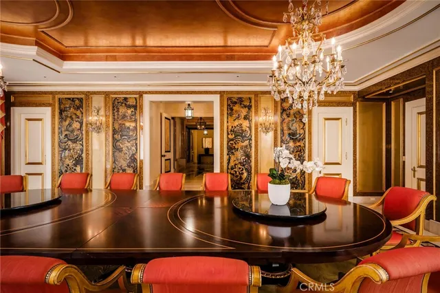 a living room with fireplace furniture and a view of kitchen