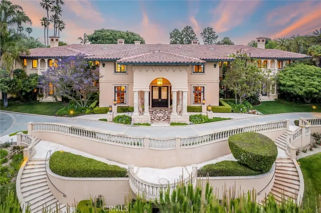 a view of a hall with furniture and a chandelier