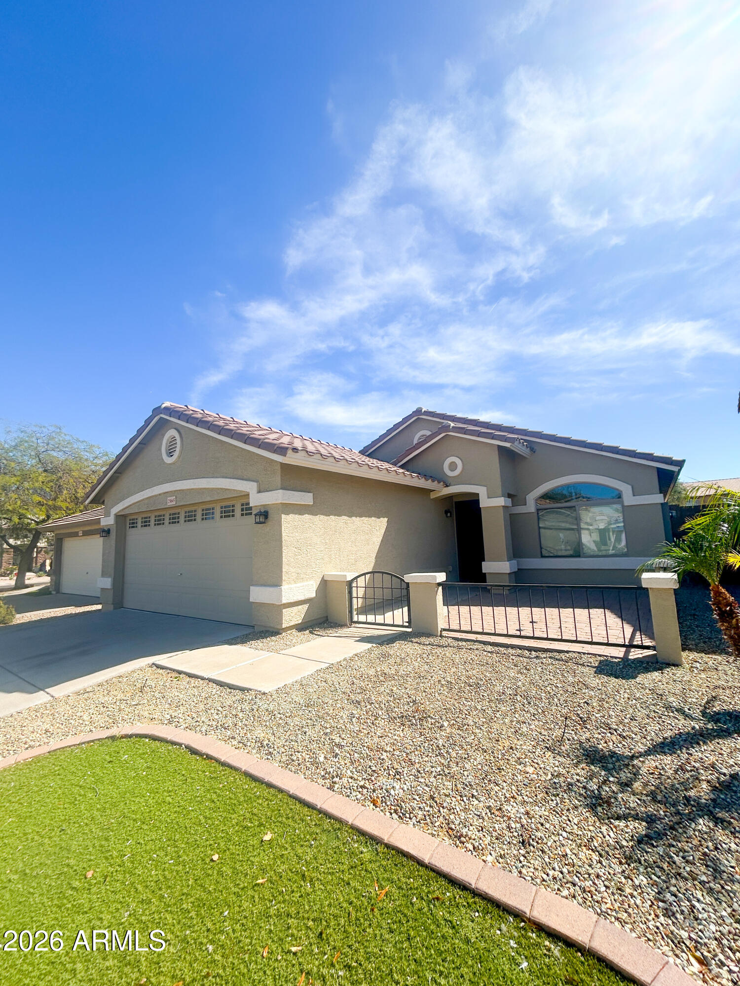 25645 West Dunlap Road Buckeye, AZ 85326 - Photo 1 of 27 a front view of a house with a yard and garage