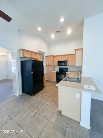 a view of a kitchen with refrigerator and microwave