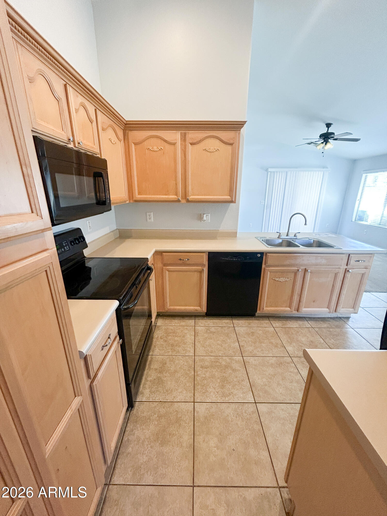 25645 West Dunlap Road Buckeye, AZ 85326 - Photo 8 of 27 a kitchen with a sink a stove top oven and white cabinets