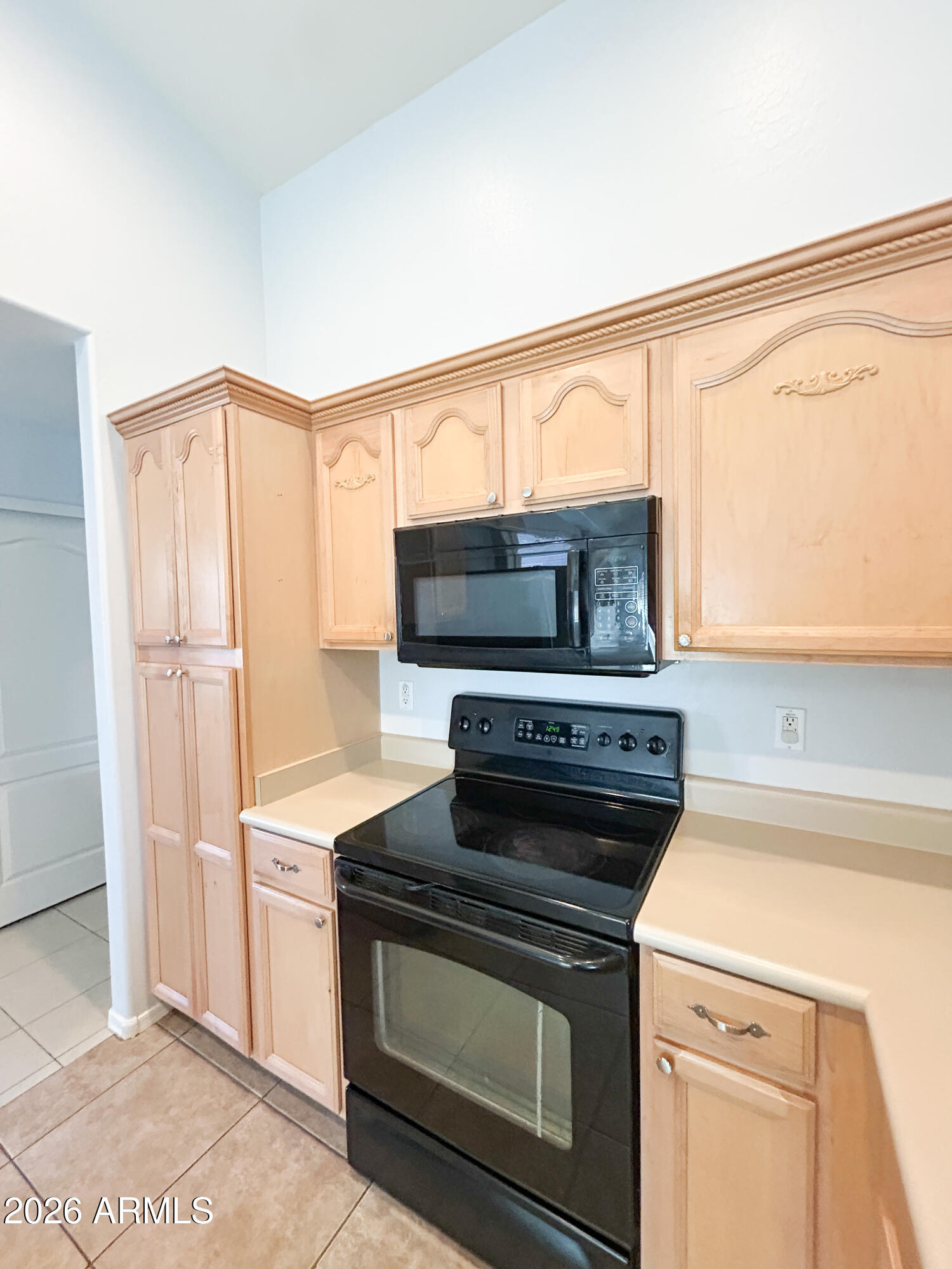 25645 West Dunlap Road Buckeye, AZ 85326 - Photo 9 of 27 a kitchen with a stove and a microwave