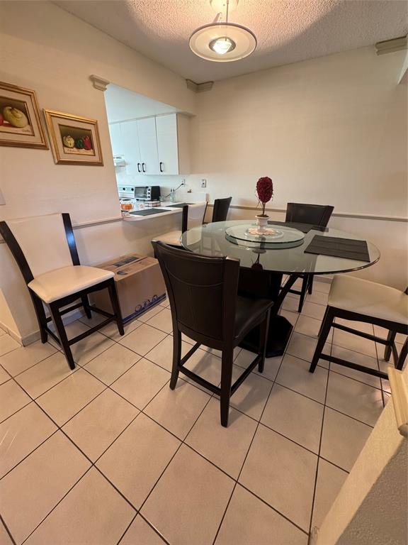 11183 Northwest 7th Street, Unit 202 Miami, FL 33172 - Photo 3 of 13 a kitchen with a table and chairs in it