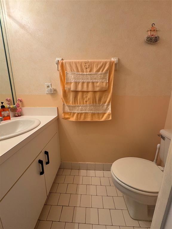 11183 Northwest 7th Street, Unit 202 Miami, FL 33172 - Photo 5 of 13 a bathroom with a sink a toilet and mirror