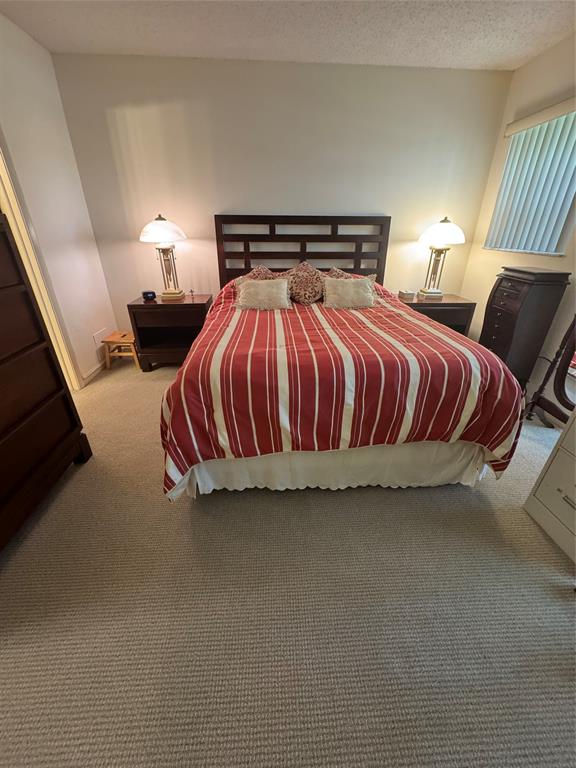 11183 Northwest 7th Street, Unit 202 Miami, FL 33172 - Photo 7 of 13 a bedroom with a bed and window