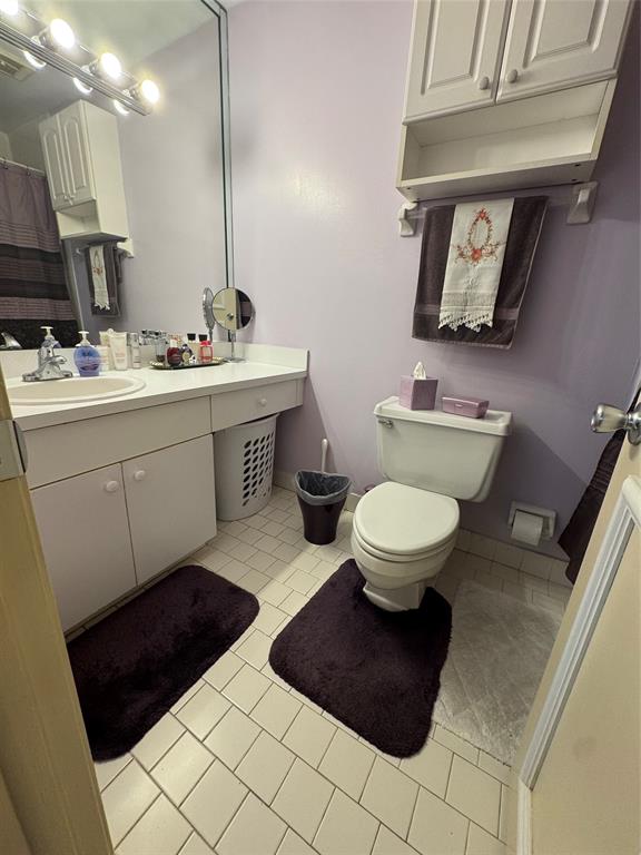 11183 Northwest 7th Street, Unit 202 Miami, FL 33172 - Photo 10 of 13 a bathroom with a toilet a sink and mirror