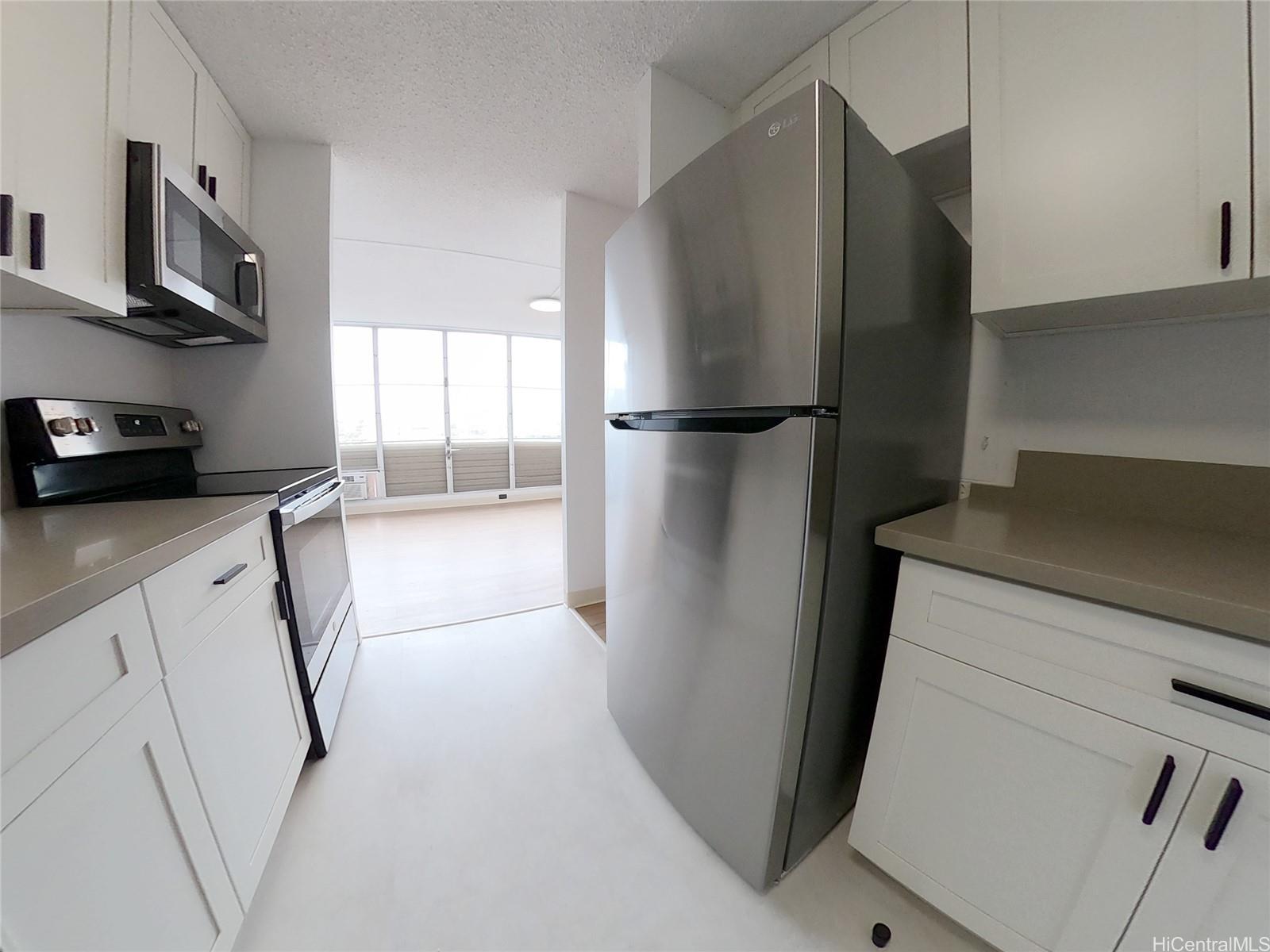 a kitchen with stainless steel appliances a refrigerator and a cabinets