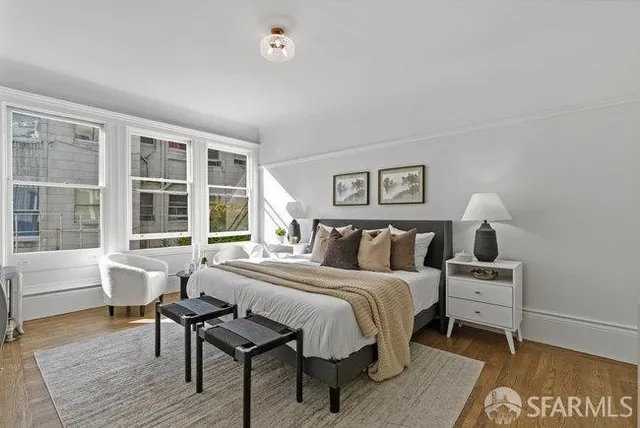 a large bedroom with a bed and glass window